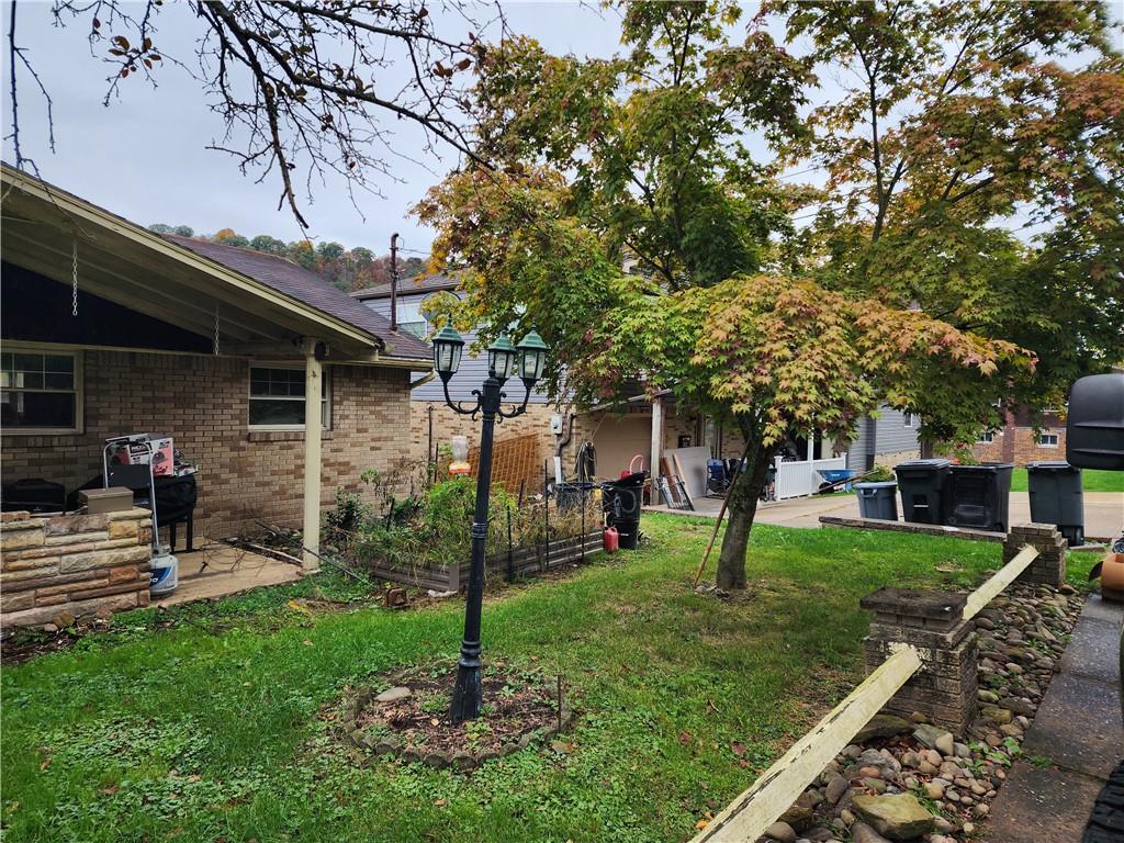 5014 3rd Street McKeesport, PA 15132 - Photo 3 of 28 a view of a chair and table in backyard of the house