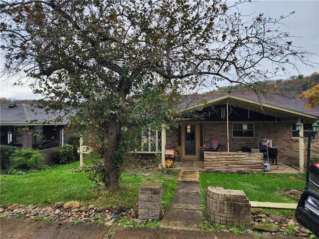 a backyard of a house with yard and outdoor seating