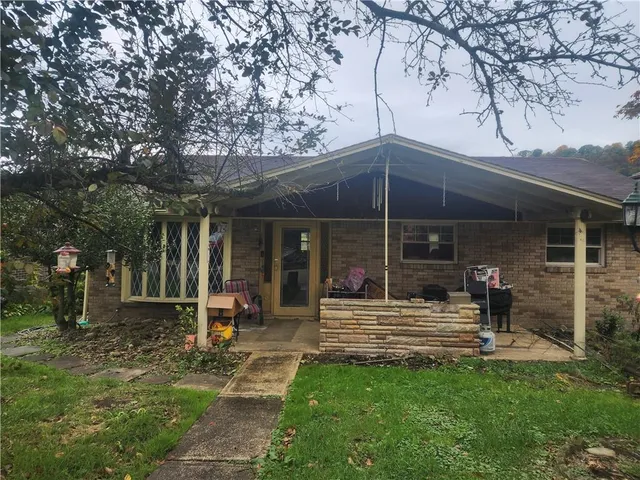 a view of a house with backyard porch and sitting area