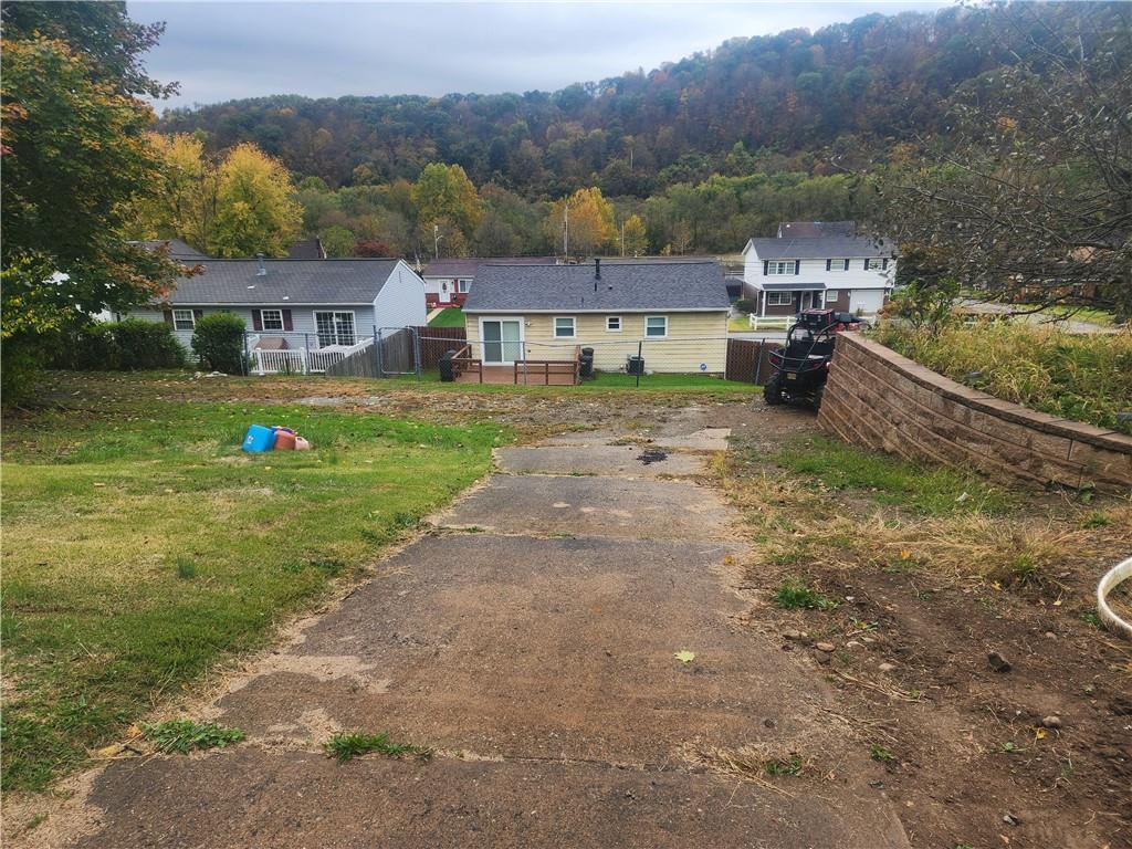 5014 3rd Street McKeesport, PA 15132 - Photo 8 of 28 a front view of house with yard and mountain view in back