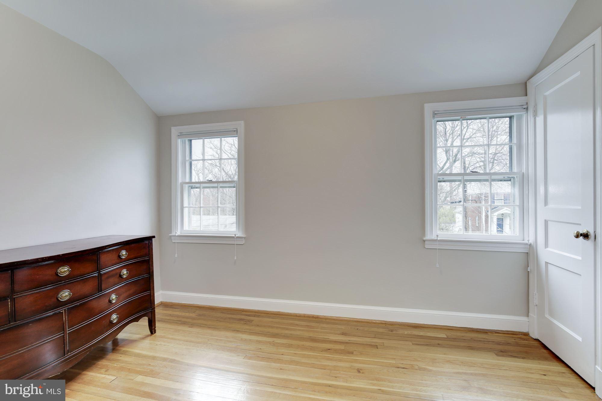 9012 Walden Road Silver Spring, MD 20901 - Photo 14 of 17 an empty room with wooden floor and windows