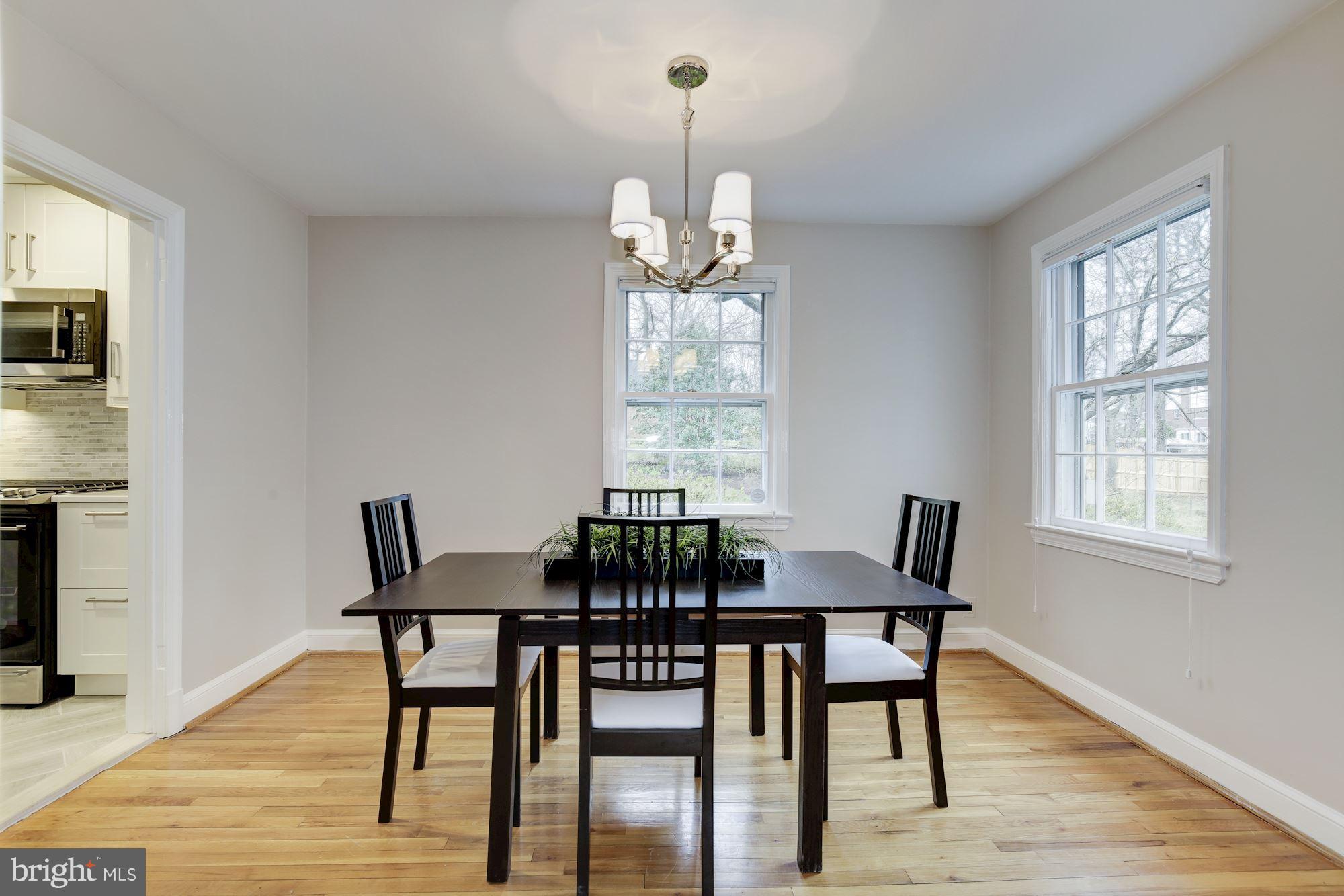 9012 Walden Road Silver Spring, MD 20901 - Photo 7 of 17 a view of a dining room with furniture window and wooden floor