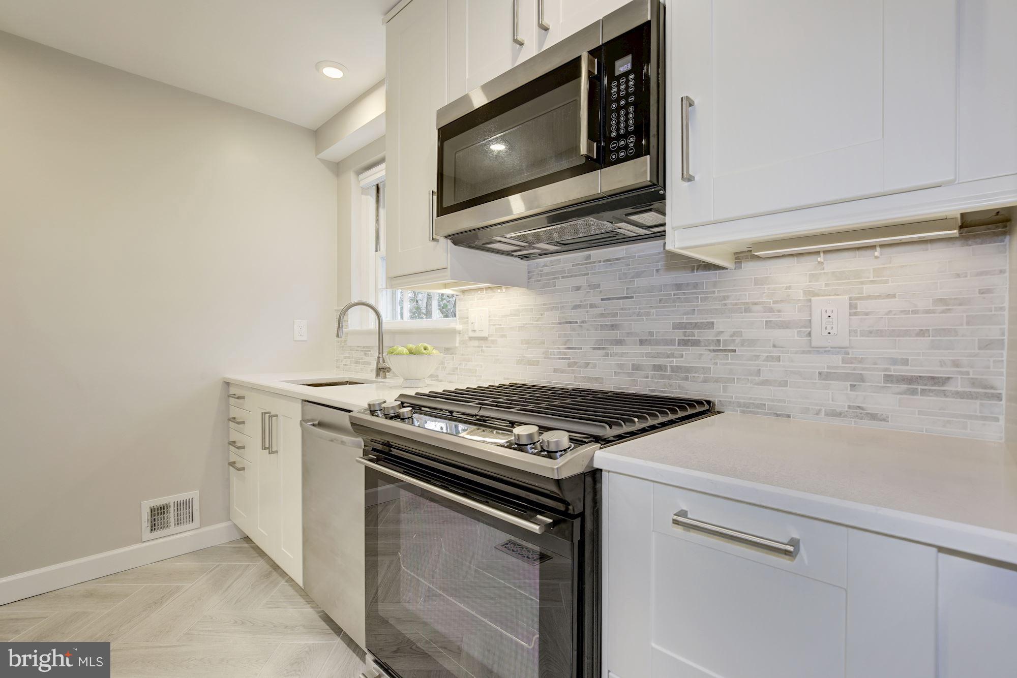9012 Walden Road Silver Spring, MD 20901 - Photo 10 of 17 a stove top oven sitting inside of a kitchen