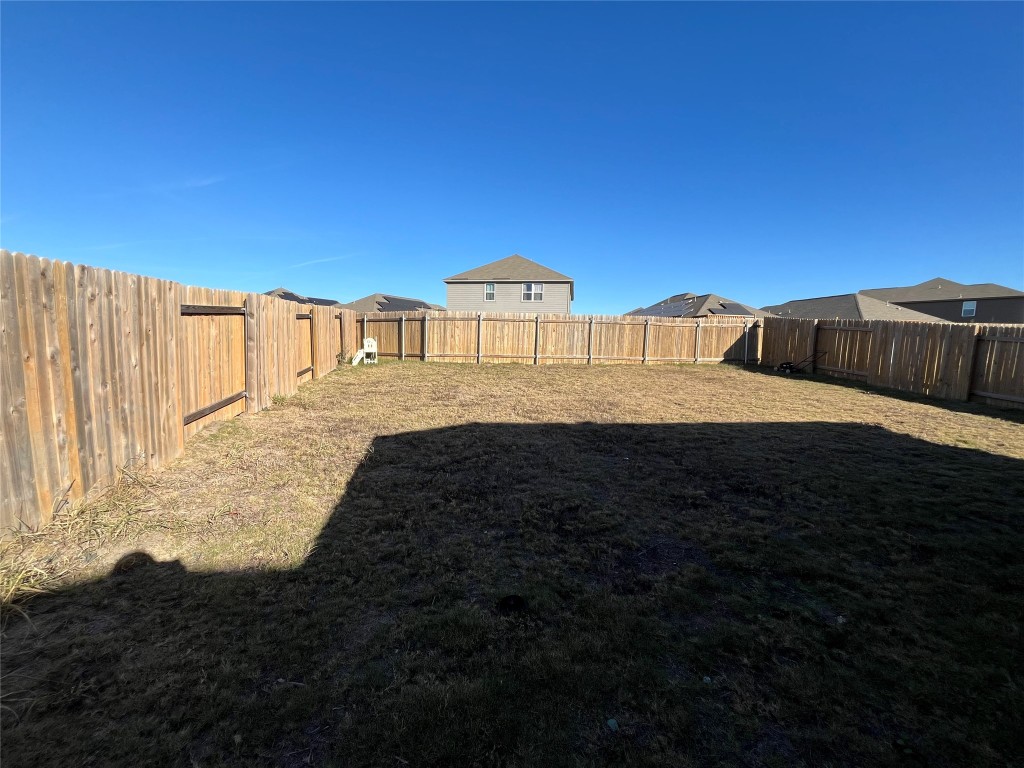 14125 Prospector Way Elgin, TX 78621 - Photo 16 of 16 Fenced backyard