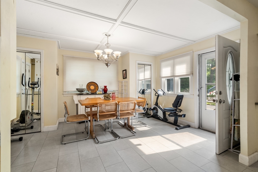 17 Chandler Road Malden, MA 02148 - Photo 12 of 19 a living room with furniture a chandelier and a dining table