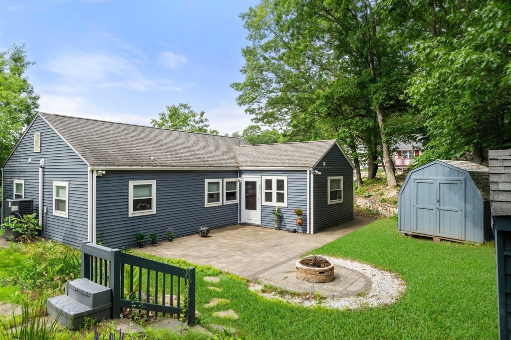 17 Chandler Road Malden, MA 02148 - Photo 3 of 19 a backyard of a house with table and chairs plants and large tree