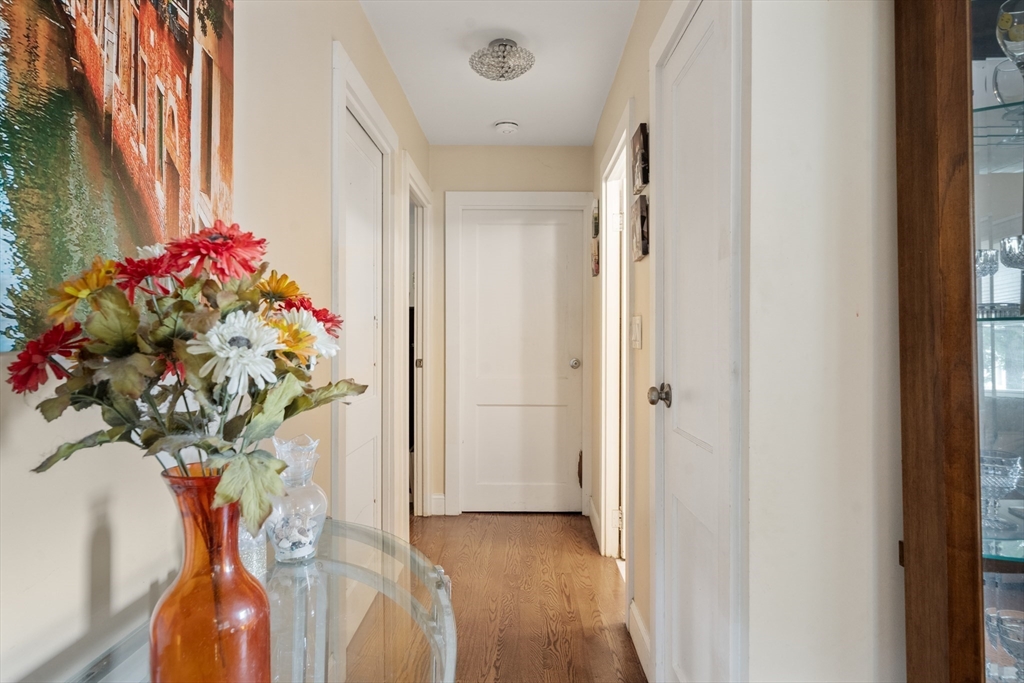 17 Chandler Road Malden, MA 02148 - Photo 7 of 19 a vase of flowers sitting on a floor next to a window