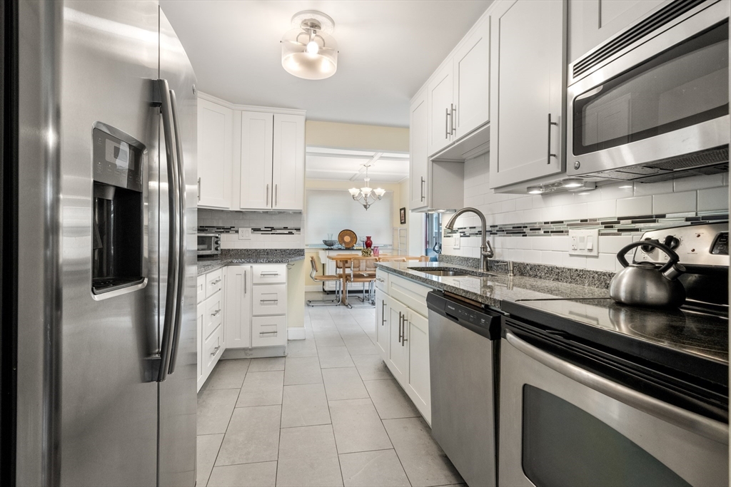 17 Chandler Road Malden, MA 02148 - Photo 8 of 19 a kitchen with stainless steel appliances granite countertop a sink and cabinets