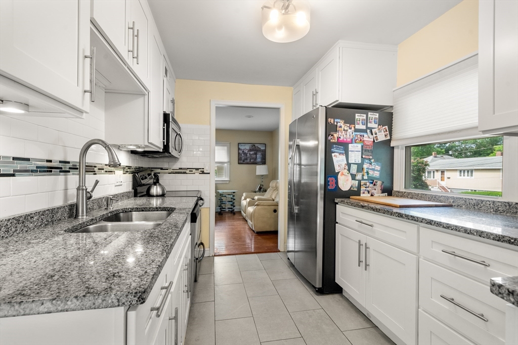 17 Chandler Road Malden, MA 02148 - Photo 9 of 19 a kitchen with sink stove and cabinets