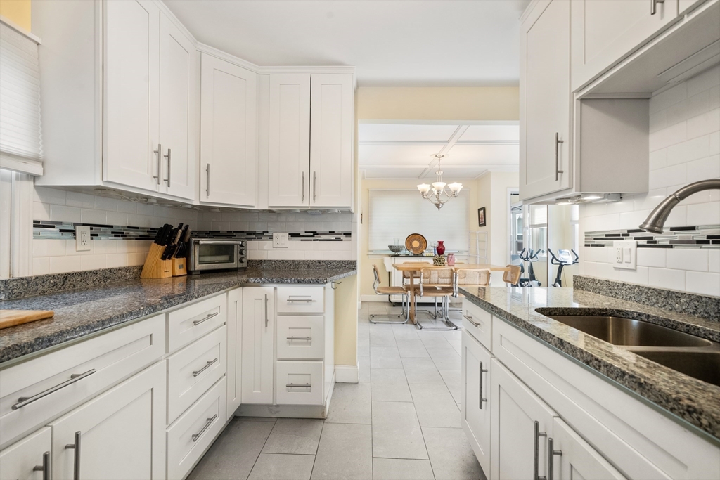 17 Chandler Road Malden, MA 02148 - Photo 10 of 19 a kitchen with granite countertop white cabinets and white appliances