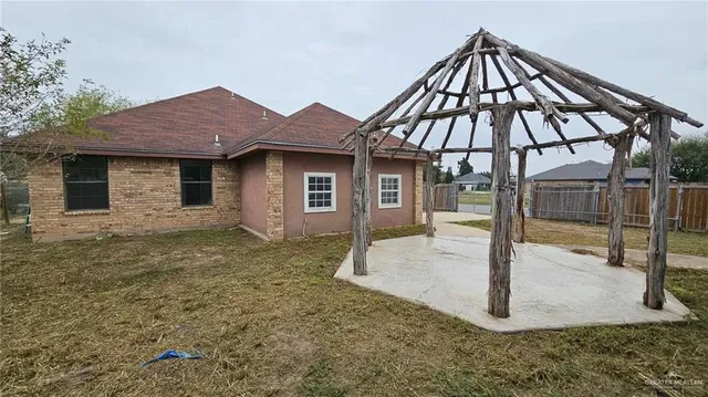 a backyard of a house with table and chairs