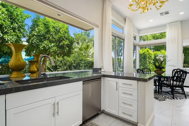 a kitchen with a sink and large window