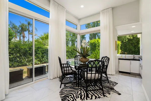 a view of a dining room with furniture window and outside view