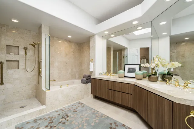 a bathroom with a double vanity sink mirror double and shower