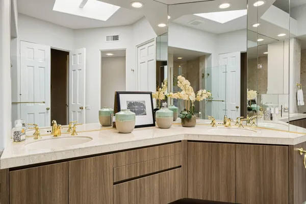 a bathroom with a sink double vanity and a mirror