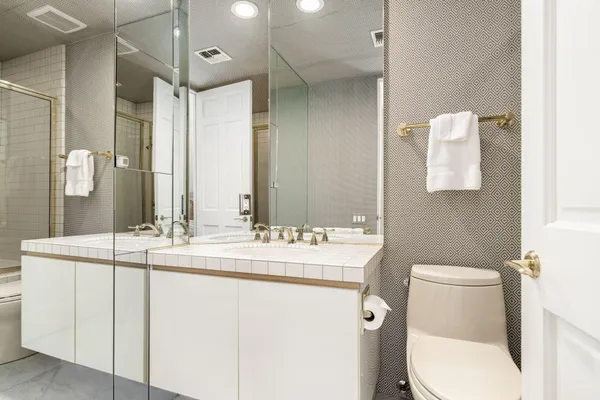 a bathroom with a toilet sink and mirror