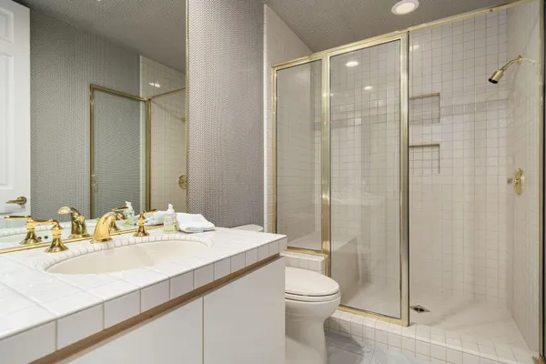 a bathroom with a sink toilet and shower