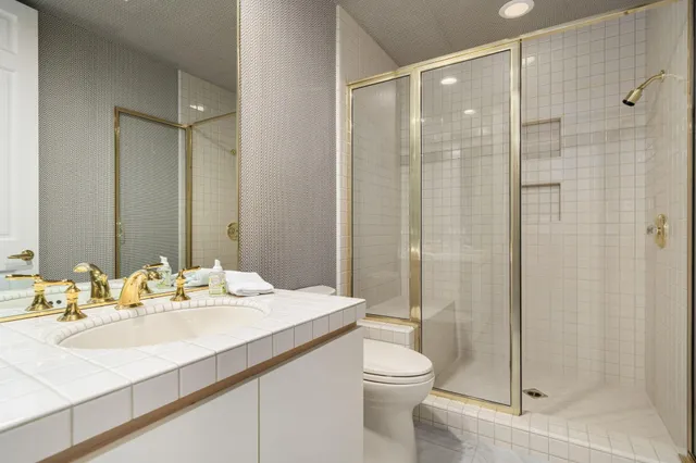 a bathroom with a sink toilet and shower