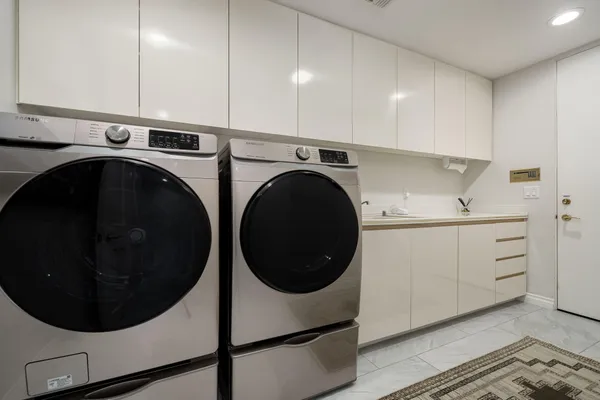 a utility room with sink dryer and washer