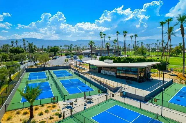a view of a swimming pool and lounge chairs