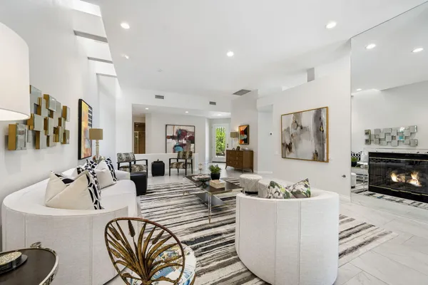 a living room with furniture kitchen view and a fireplace