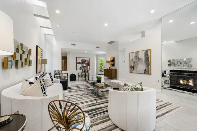 a living room with furniture kitchen view and a fireplace