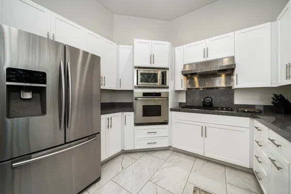 a kitchen with stainless steel appliances and cabinets