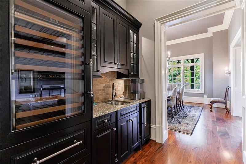 15750 Freemanville Road Milton, GA 30004 - Photo 12 of 30 a kitchen with granite countertop wooden cabinets and stainless steel appliances