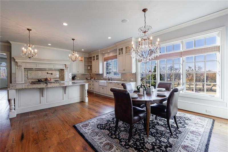 15750 Freemanville Road Milton, GA 30004 - Photo 14 of 30 a view of a dining room with furniture window and wooden floor
