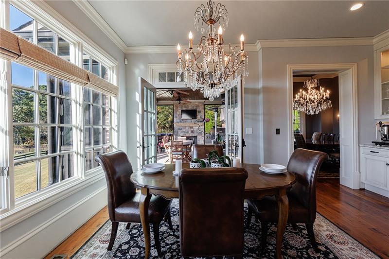 15750 Freemanville Road Milton, GA 30004 - Photo 15 of 30 a view of a dining room with furniture a chandelier and wooden floor