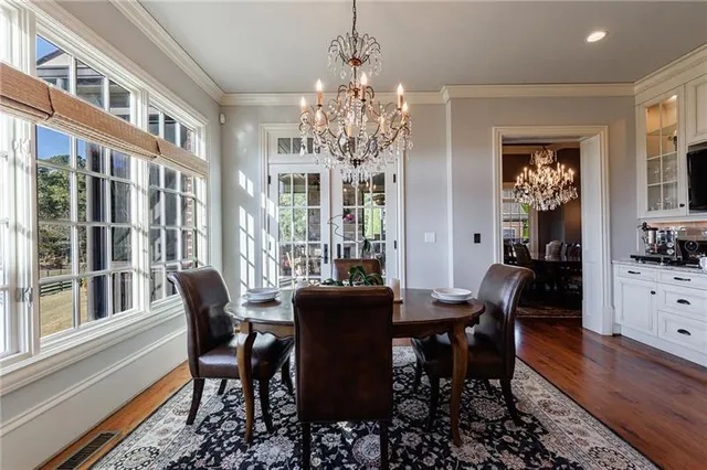 a view of a dining room with furniture and chandelier