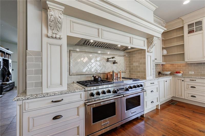 15750 Freemanville Road Milton, GA 30004 - Photo 18 of 30 a kitchen with stainless steel appliances white cabinets and a stove