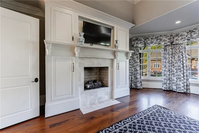 a living room with a flat screen tv and a fireplace