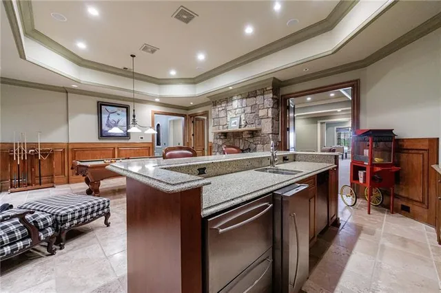 a kitchen that has a sink and a stove in it