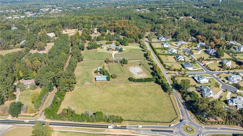 15750 Freemanville Road Milton, GA 30004 - Photo 4 of 30 an aerial view of residential houses with outdoor space
