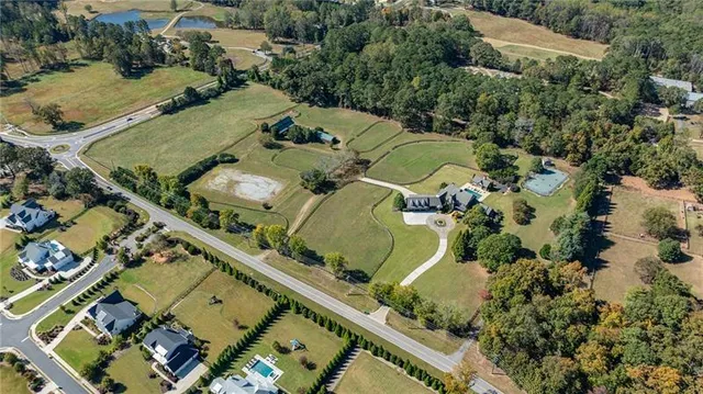 an aerial view of a residential houses with outdoor space