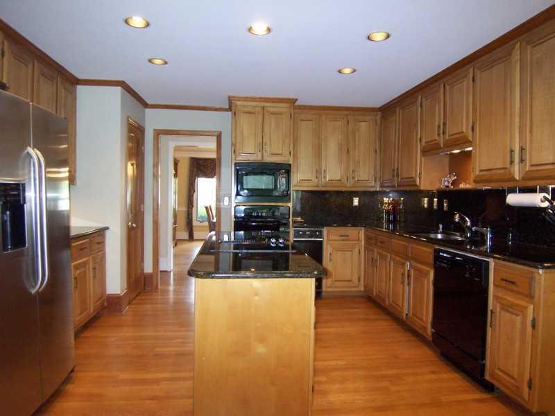 Kitchen. Large gourmet kitchen with top of the line GE appliances and granite countertops and island.