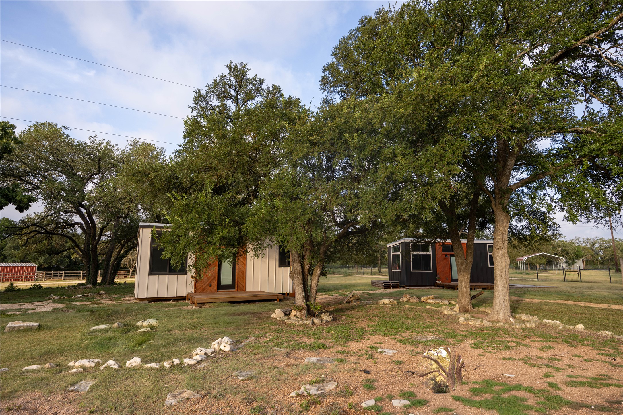 240 Lanier Ranch Road, Unit B Driftwood, TX 78619 - Photo 12 of 26 Two charming tiny homes are nestled among mature trees on a sprawling, verdant lot.