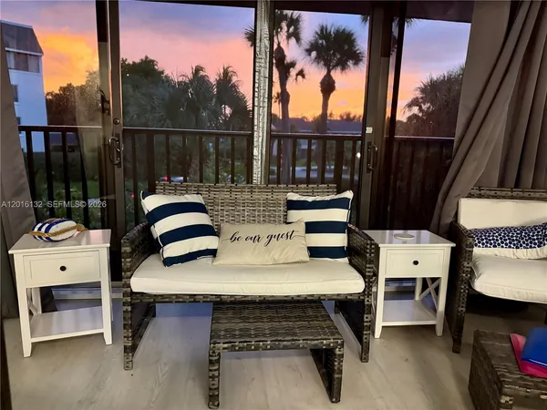 a balcony with table and chairs