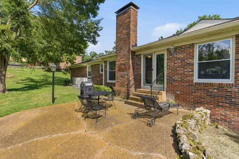 a house view with a sitting space and garden