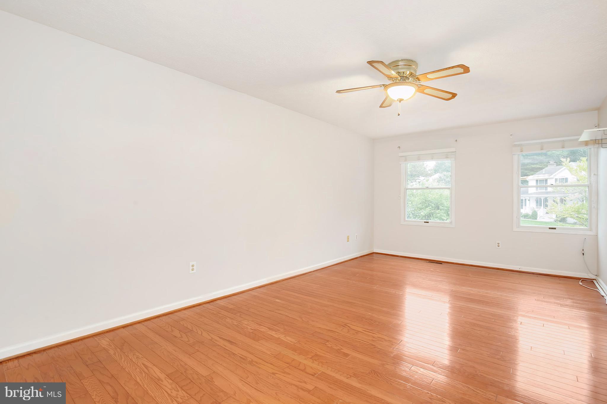 14908 Windmill Terrace Silver Spring, MD 20905 - Photo 13 of 30 an empty room with wooden floor fan and windows