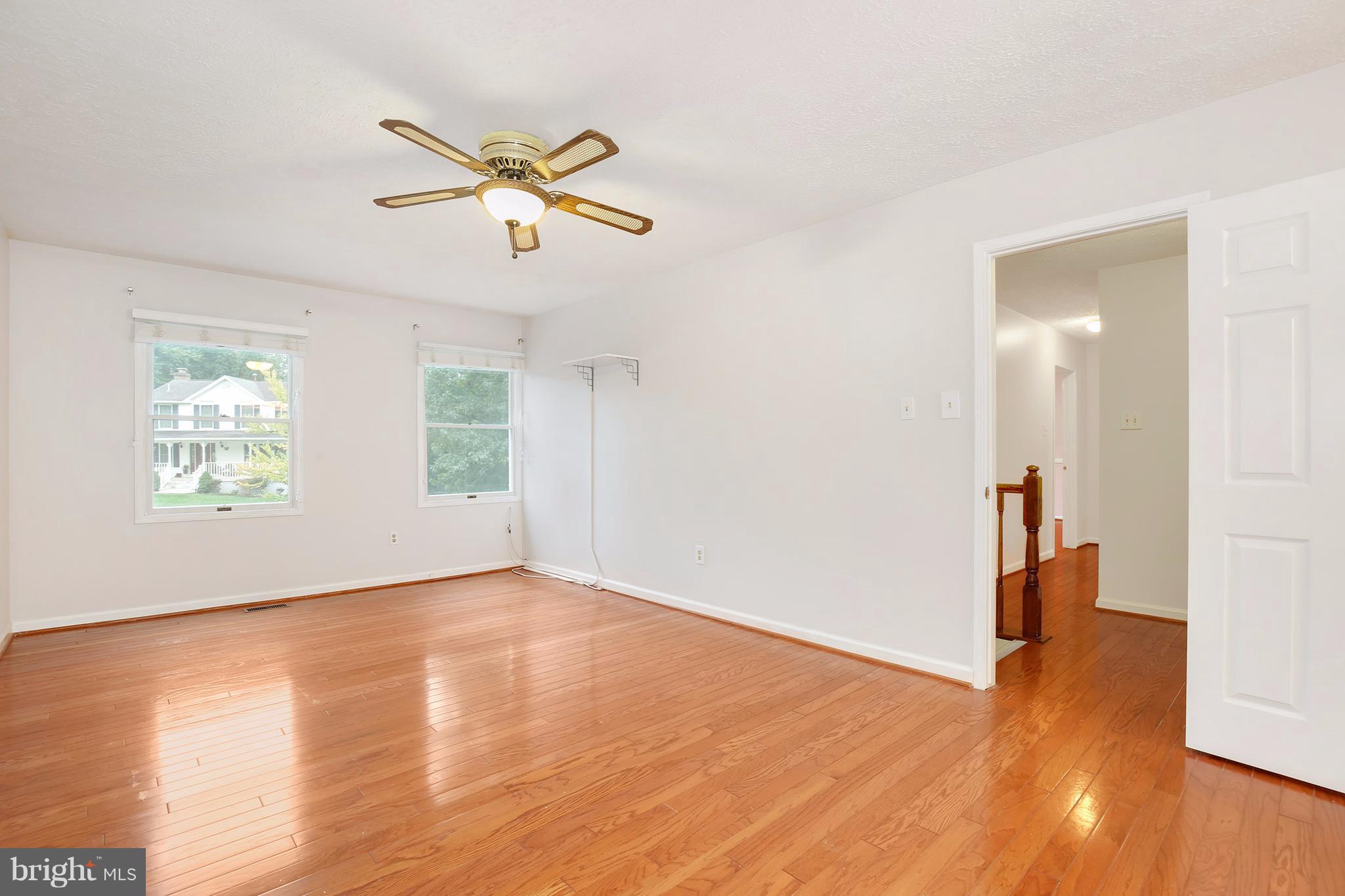 14908 Windmill Terrace Silver Spring, MD 20905 - Photo 14 of 30 a view of empty room with wooden floor and fan