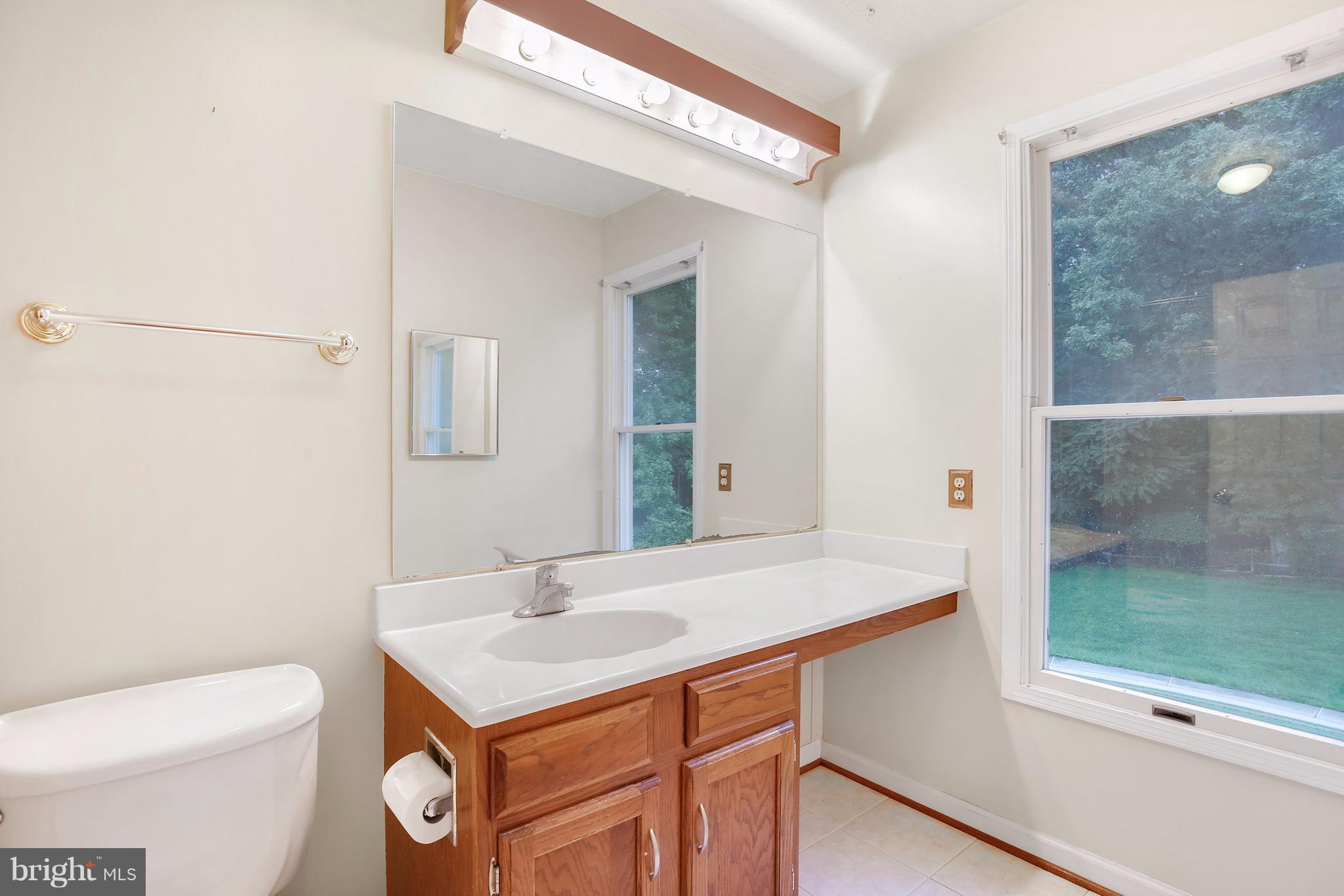14908 Windmill Terrace Silver Spring, MD 20905 - Photo 15 of 30 a bathroom with a sink a toilet a mirror and shower