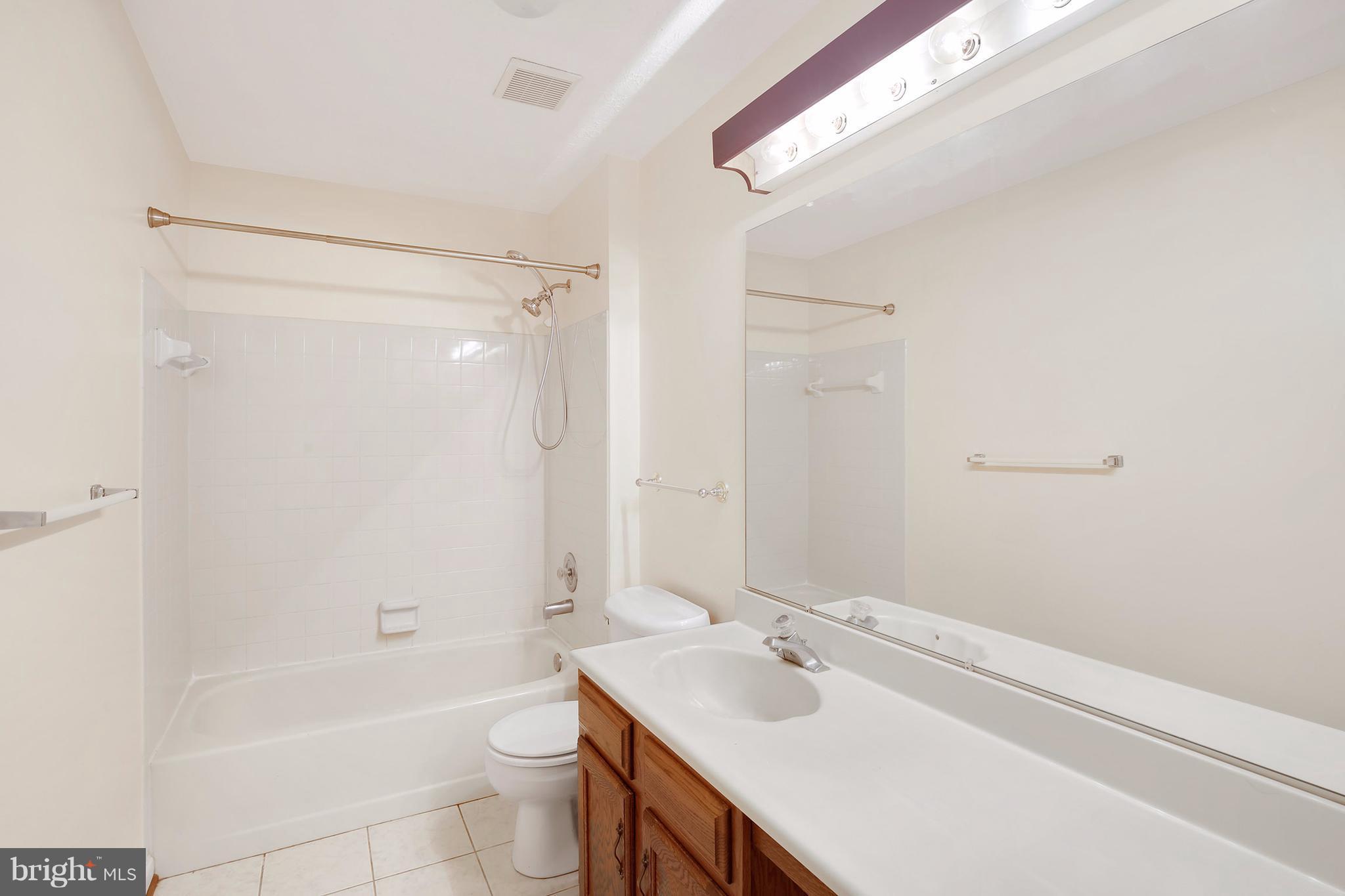 14908 Windmill Terrace Silver Spring, MD 20905 - Photo 22 of 30 a bathroom with a sink a toilet and shower