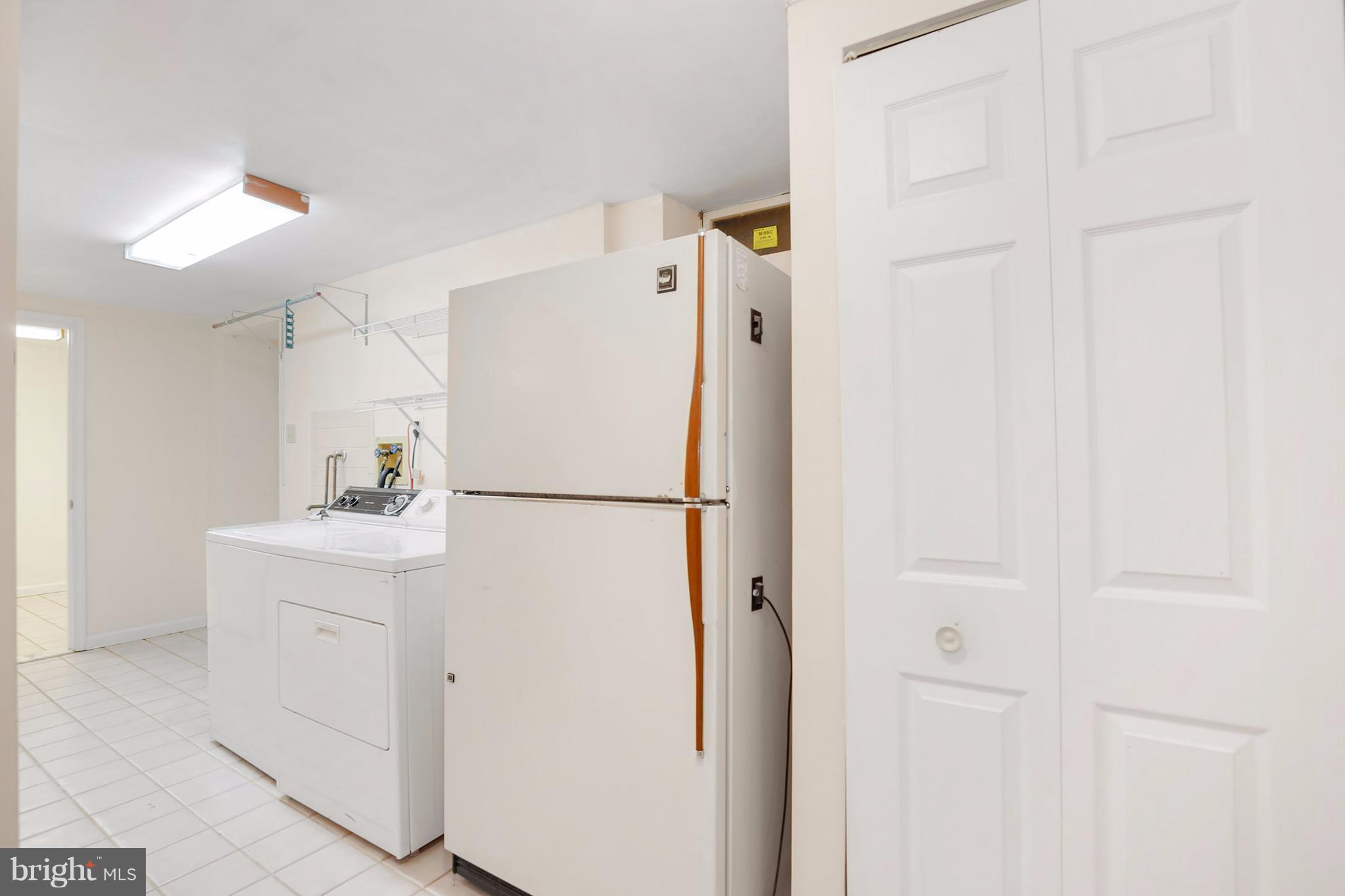 14908 Windmill Terrace Silver Spring, MD 20905 - Photo 23 of 30 a white refrigerator freezer sitting in a kitchen
