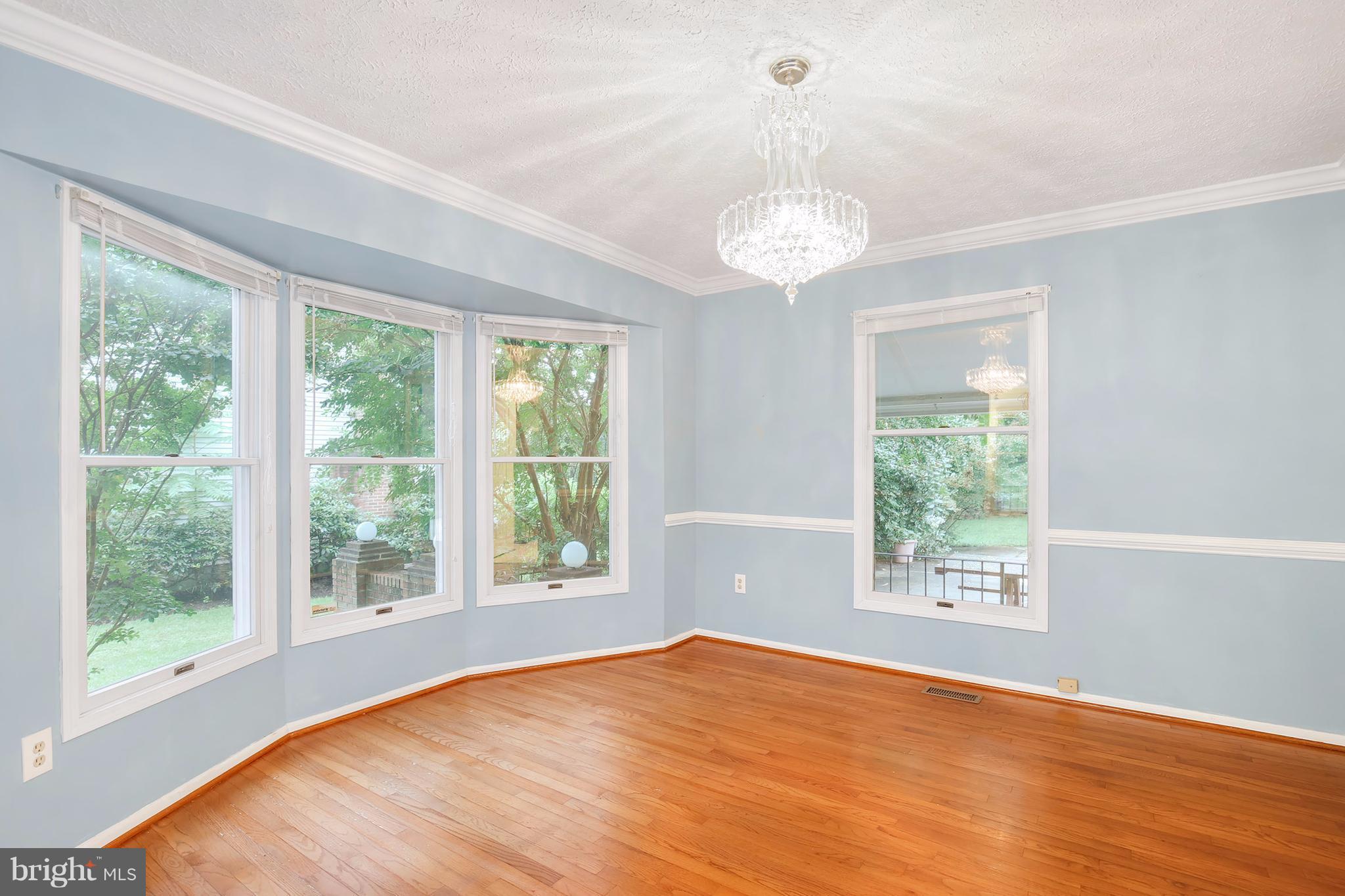 14908 Windmill Terrace Silver Spring, MD 20905 - Photo 4 of 30 a view of an empty room with wooden floor and a window
