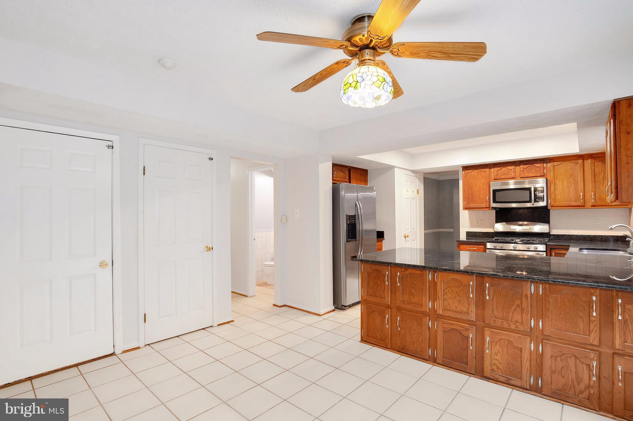 14908 Windmill Terrace Silver Spring, MD 20905 - Photo 10 of 30 a large kitchen with stainless steel appliances granite countertop a refrigerator and a sink