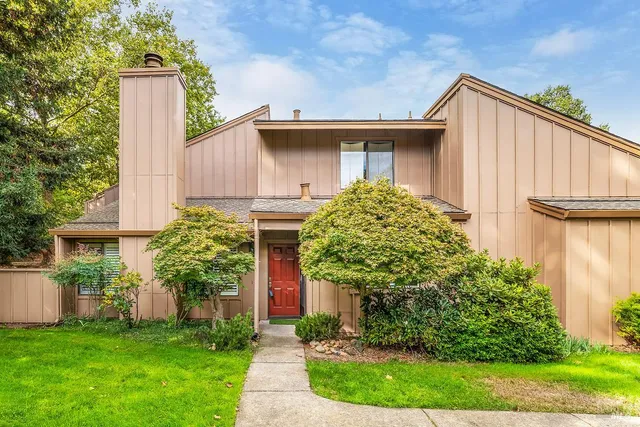 a view of a house with a yard and plants