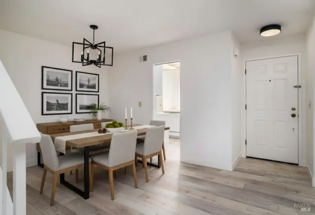 a view of a dining room with furniture wooden floor and chandelier