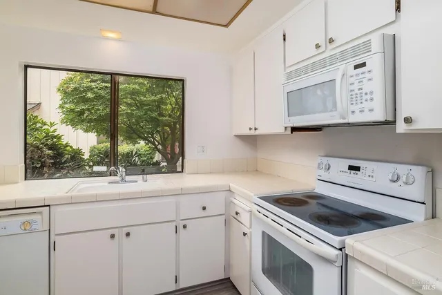 a kitchen with a stove and a white cabinets